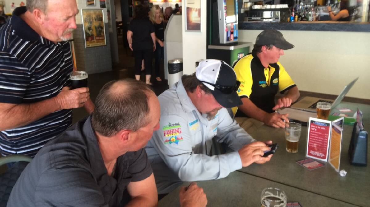 PHOTO TIME: Officials Stuart Hindson and Graeme Dawson check photos and tabulate from Day 1.