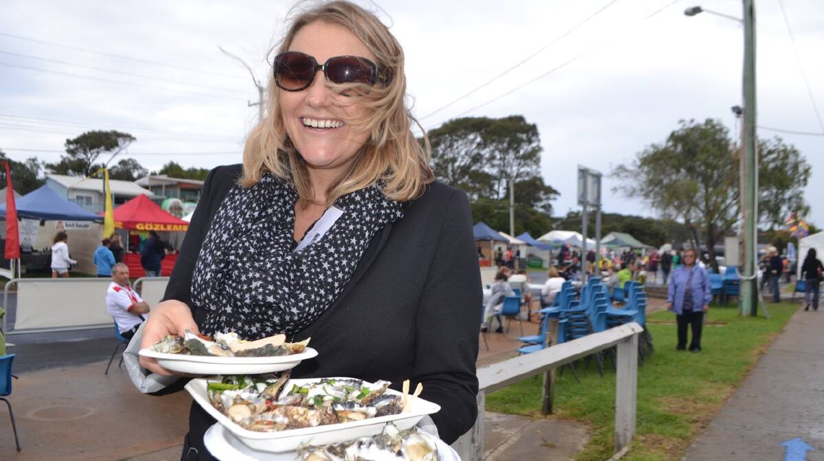 AOC GROWER: Shoalhaven oyster grower and Australia's Oyster Coast representative Jess Zealand helps herself to lots of oysters at the Narooma Oyster Festival. Photo Stan Gorton 