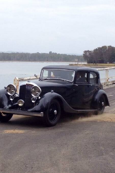 SPEEDING CAR: Our correspondent Josh Mccue snapped this shot of the classic car crossing the Wallaga Lake bridge for the Angelina Jolie directed film "Unbroken".