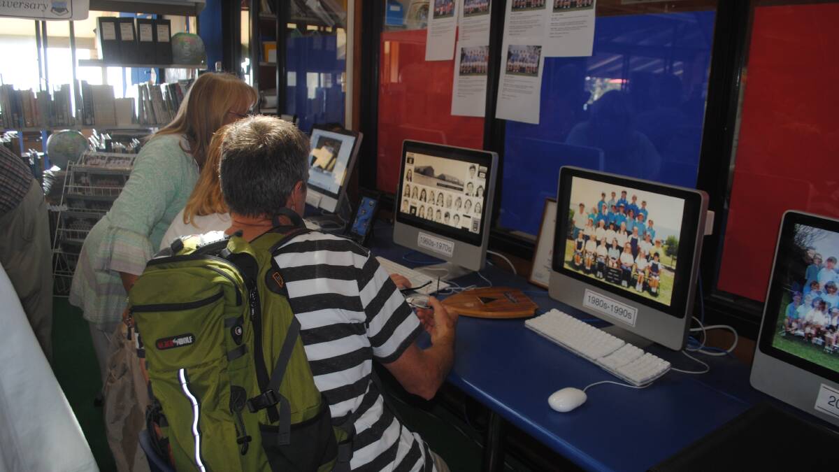 COMPUTERS: Checking out old school photos on the Narooma Public School Library computers.