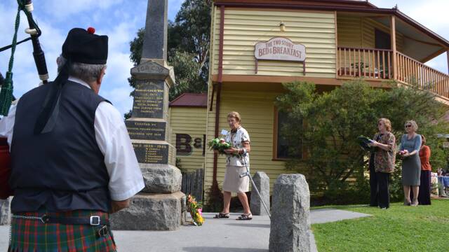 LEGATEE WREATH: Susan LeBars from Narooma Legacy lays a wreath at the Tilba War Memorial on ANZAC Day.