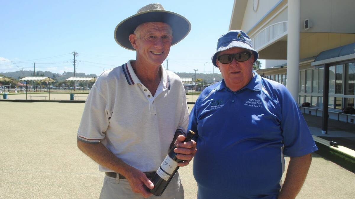 WINNER: Rod Holman was presented with a bottle of wine for his resting toucher by presidents of the Narooma Men’s Bowling Club at their Friendship Bowling Day at Club Narooma on Friday. 