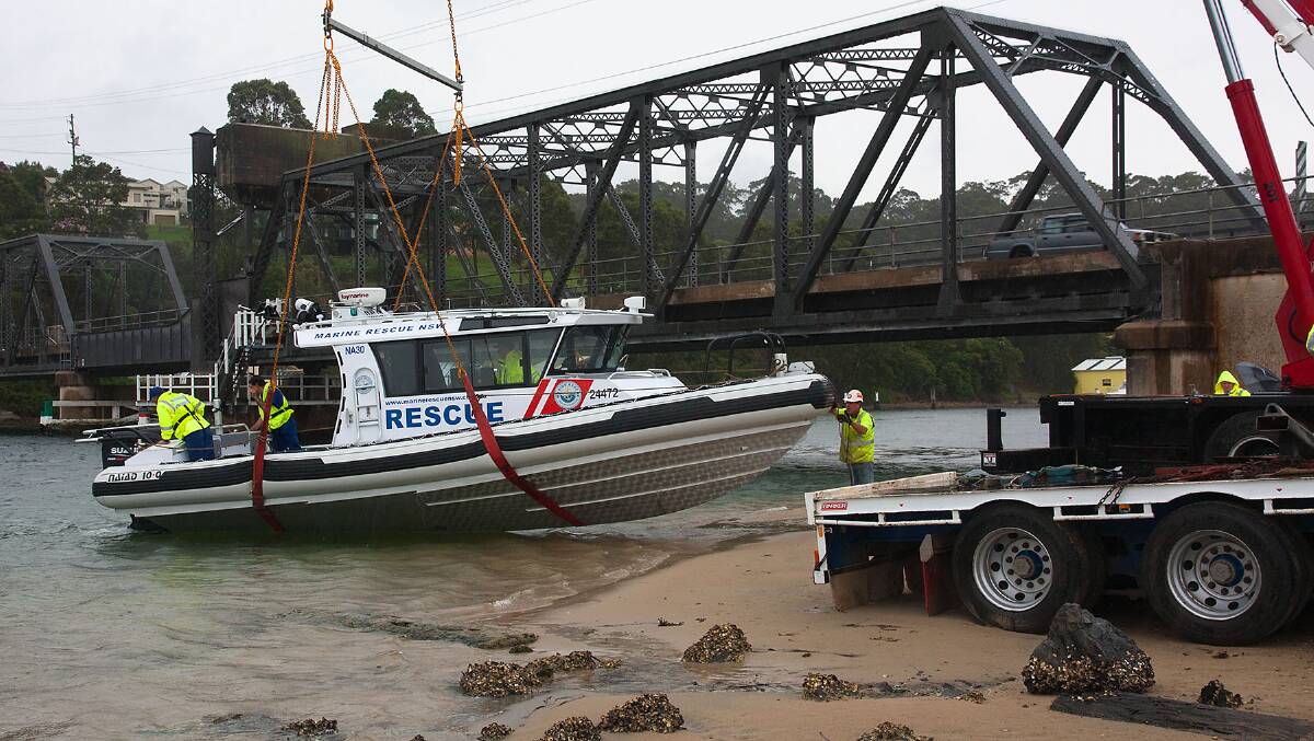VESSEL LAUNCH: The new 10.2 metre Naiad rescue vessel is launched by Marine Rescue Narooma at the Narooma Bridge on Thursday in the rain. Photo by Brian Gunter  