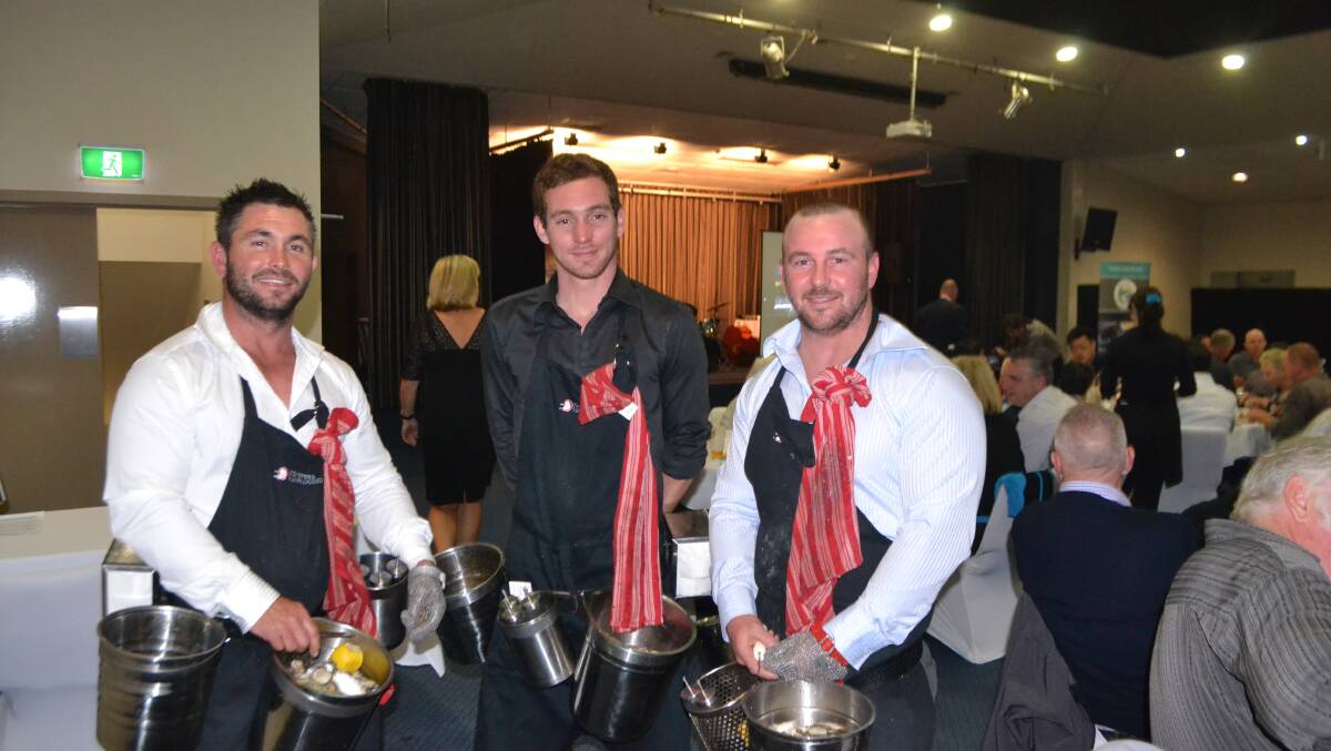 1000 SHUCKED: The Ralston brothers Ben and John and their professional French shucker still at it at the Narooma Oyster Festival dinner at the Narooma Golf Club on Saturday night after almost 10 hours and over a thousand oysters. Photo Stan Gorton 