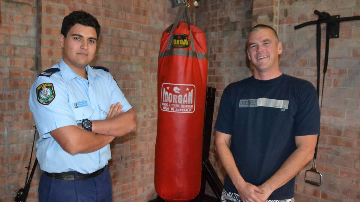 BOXING OFFICERS: Senior Constable Gavin Warner with fellow Narooma officer Scott Wharfe, who is preparing for his sparring bout. 