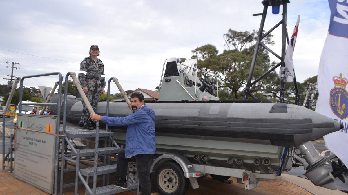 NAVY RHIB: Narooma local and Marine Rescue volunteer Rob O'Brien checks out the Navy's RHIB with Able Seaman Sarra Gill at the Narooma Oyster Festival. Photo Stan Gorton