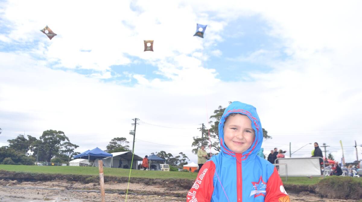 KITE BOY: Jack Klose flies a kite at the Narooma Oyster Festival. Photo Stan Gorton