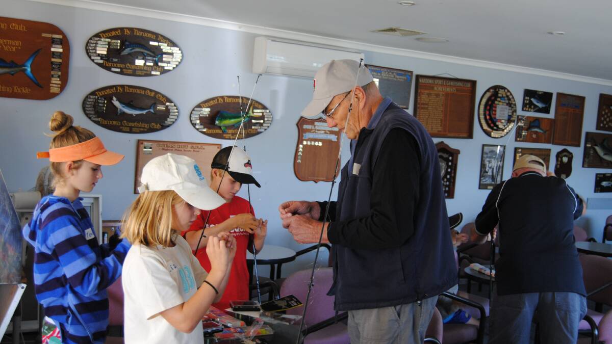TYING KNOTS: Jan Hemmingsen, one of the NSGFC committee members, tying knots with the kids at the club clinic. 