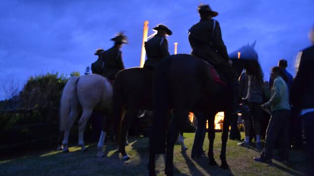 MOUNTING UP: 7th Bemboka Light Horse and their horses head down to the Bermagui War Memorial at the start of the dawn service.