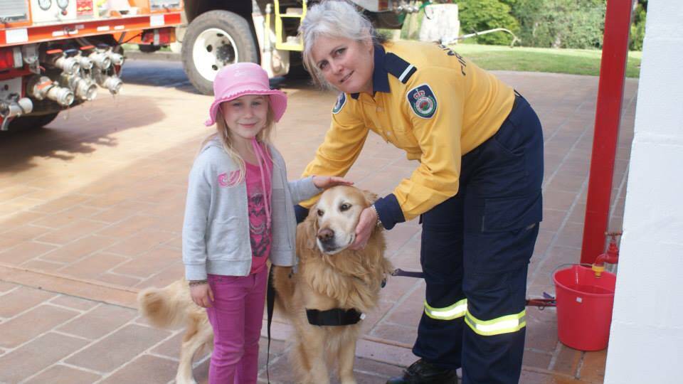 DEPUTY DOG: Deputy dog Bundy together with Krystal Bailey and Deputy Captain Gilly Kearney at last year’s open day. Pets and kids need to be considered when planning your Bush Fire Survival Plan.  