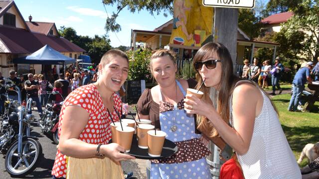 LEMONADE LADIES: Suzie Julian-Bradley and Jenna Le Gras of the Tilba Teapot offer some delicious lemonade to Alicia Cordia from River Cottage at the Tilba Festival on Easter Saturday.