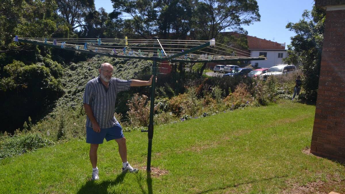 CHURCH CONCERN: Narooma Catholic Church spokesman Kurt Pisk shows how close the proposed car park is to the church accommodation and also what a large ravine that is going to require 1850 tonnes of fill. 