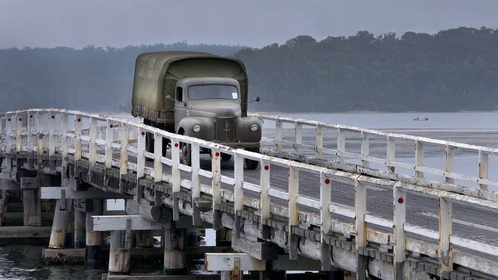 MORE ACTION: Chilby Photography sent us this photo of the replica Japanese army truck crossing Wallaga Lake bridge. 