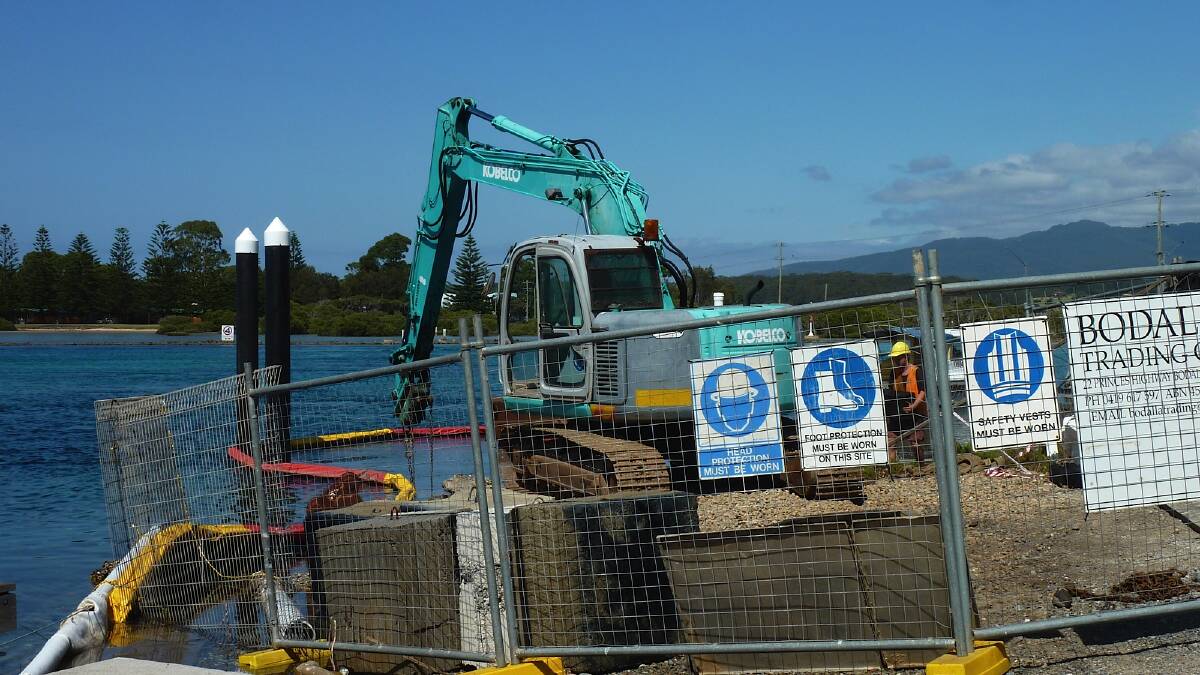 WHARF CONSTRUCTION: Workers on site constructing the revamped berthing area at Mill Bay for Marine Rescue Narooma’s new rescue vessel and also its Jetskis. 