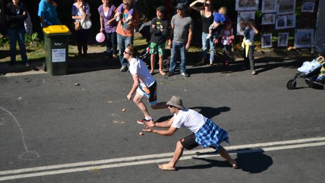 EGG TOSSERS: Winners of one of the final heats of the Tilba Festival Easter egg toss Tony Cameron of Canberra making a lunge for his egg.