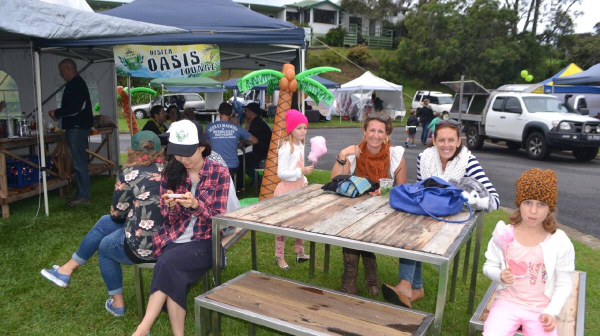 BAY LADIES: Justine Searson and Sonya Crawford and kids Jasmine and Chelsea all from Batemans Bay at the Oyster Oasis Lounge set up by the Ulladulla Oyster Bar at the Narooma Oyster Festival. Photo Stan Gorton