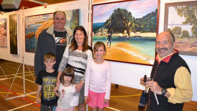 SELF PORTRAIT: Narooma area artist Giovanni Carrus with his spear fishing self portrait and his family John and Mandy Vella and Natasha, Samantha and Jack visiting from Camden.