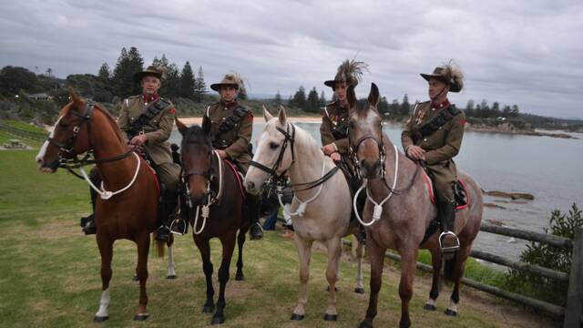 LIGHT HORSE: Standing guard at the dawn service were four members of the 7th Bemboka Light Horse – Trooper Stuart Hull on Domino, Corporal Craig Cowgill on Victor, Trooper Isaac Reid on Asta La Vista and Sergeant Chris Reid on Chappy. 