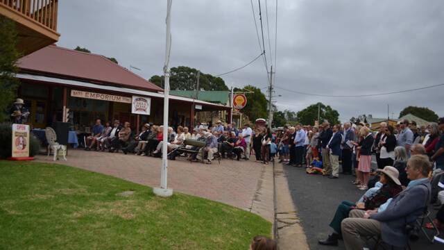 LARGE CROWD: A large crowd attended the Tilba ANZAC Day march and ceremony held outside Bates Store and Two Story B&B.