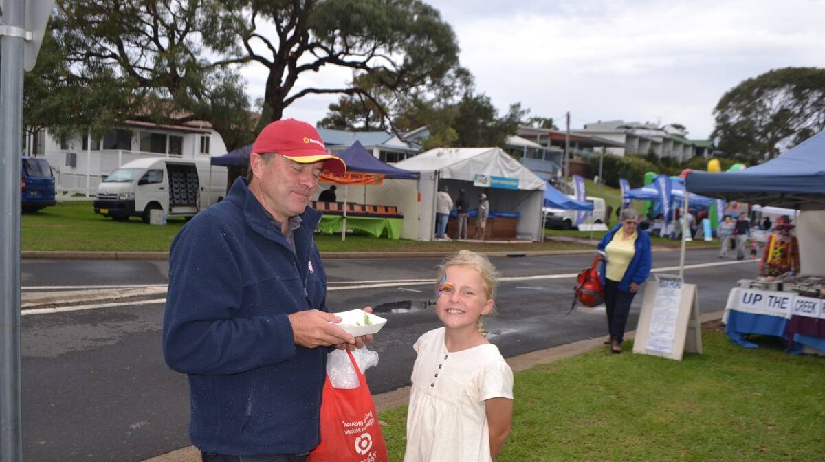 FESTIVAL WORKER: Narooma Oyster Festival committee worker Dave Moore and daughter enjoy the day. Photo Stan Gorton