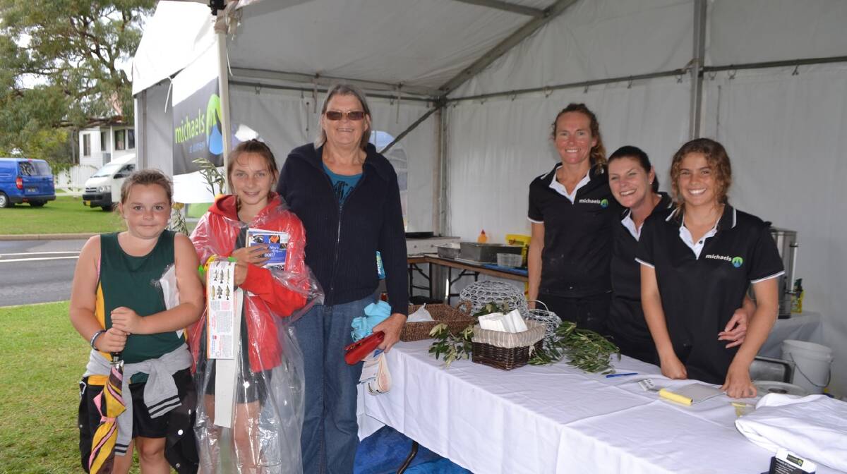 AT MICHAELS: Hanging out at the Michael's at Dalmeny tent at the Narooma Oyster Festival are Sammy and Abbey Dawson and Tralee Snape and workers Vanessa Donald, Tania Hextell and Aja Schofield. Photo Stan Gorton