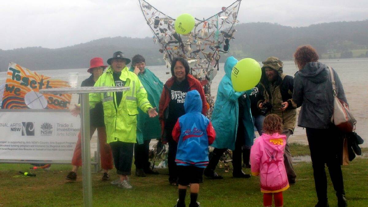 ADMIRERS: Despite the rain, there were many admirers of the kites made by seven local clubs and high school and primary students. Photo by Rosy Williams 