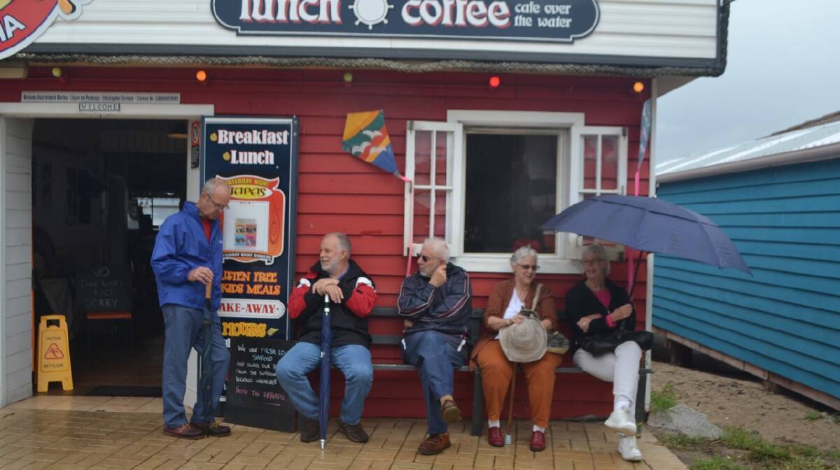 SEEKING SHELTER: Seeking shelter at The Quarterdeck at the Narooma Oyster Festival. Photo Stan Gorton