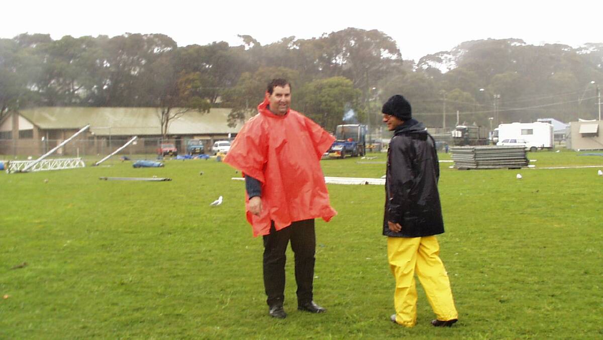 FROM THE VAULTS: Narooma Blues Festival founder and promoter Neil Mumme had to deal with some rain on NATA Oval back in the year 2000 and is pictured with stage and marquee manager Ross Patterson who still works on the festival.  