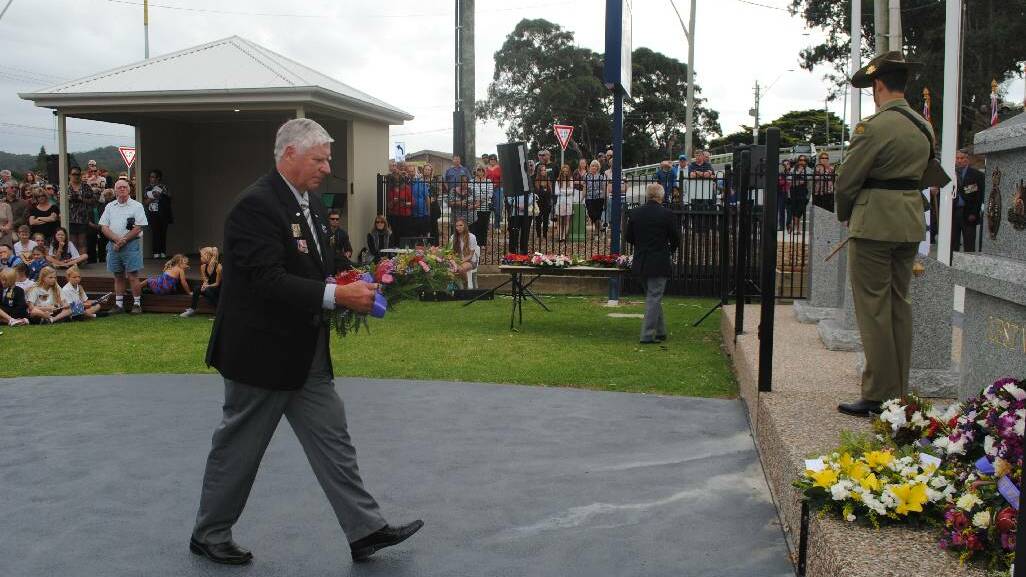 WREATH: Laying a wreath at the Narooma War Memorial is Club Narooma president Graham Reeve.