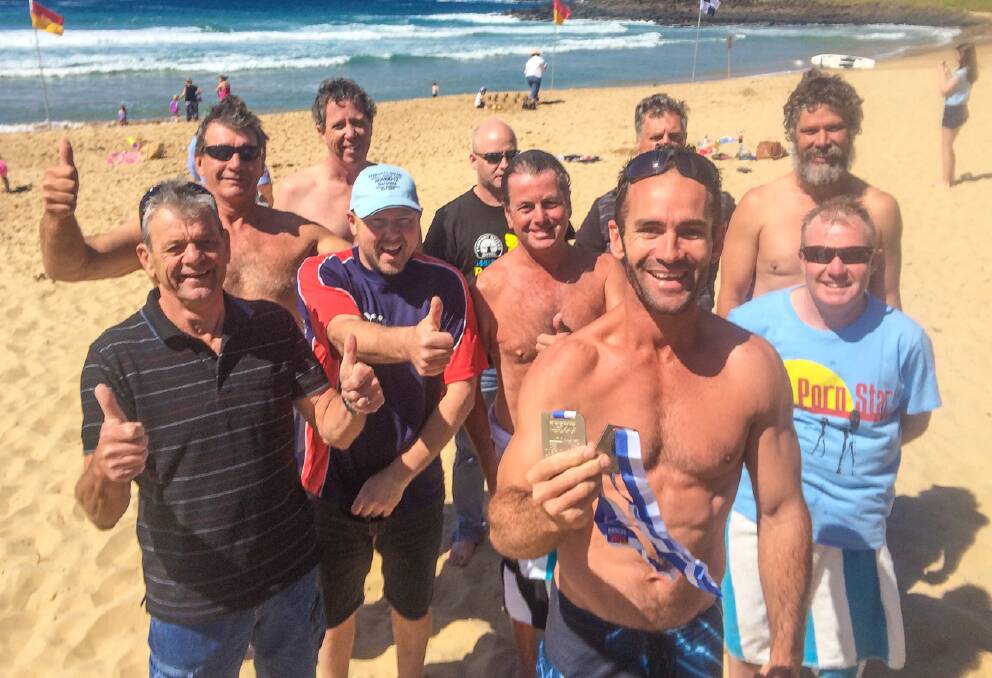HOMEWARD BOUND: Dual silver medalist Justin Bennett at Kiama on the way home on Monday with Narooma winter swimmers including his uncle Trevor Bennett, Steve Dobson, John Carruthers, Glenn Bywater, Scott Cavanagh, Chris Black, Greg Willis, Ben Stainer and Mark Rogerson.