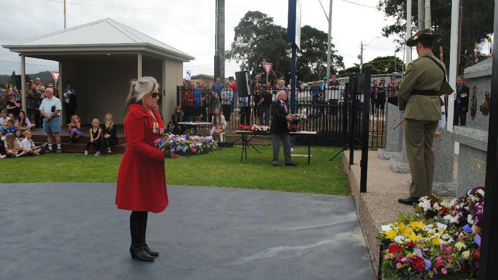 WREATH: Laying a wreath at the Narooma War Memorial is Rural Fire Service member Gillie Kearney.