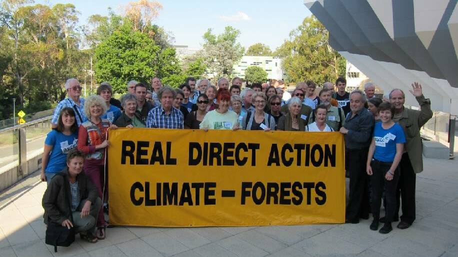 DIRECT ACTION: Some of the 90 attendees at the Australian Forest and Climate Forum in Canberra included Mike Thompson, waving with relief that the successful forum was over, and Prue Acton on left of sign.