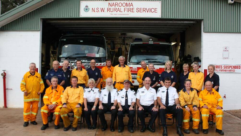 HAPPY 75TH: Pictured here are most of the members of Narooma Rural Fire Brigade. There are over three hundred years’ worth of fire fighting experience between these members, ranging from a few months, to over forty years for some. From front left Rhys Kenna, Daniel Bailey, Gilly Kearney, Paul Page, Adrian Cooper, Mick Marchini, Phil Jenkins, Sophie Taylor and Allan Wood. Back from left John Kinkade, Chris Joannides, Austin Farrell, Mick Hooper, Peter Philips, Brodie Dodge, Mick Jardine, Peter Kearney, John Hinds, Ellyn Taylor, Jane Taylor and Eadie Lee.