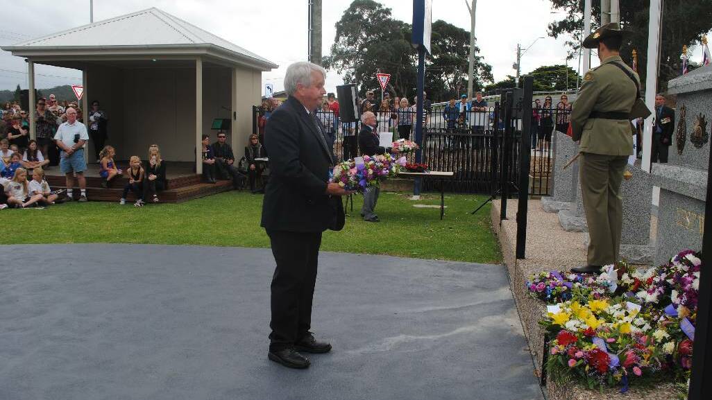 WREATH: Laying a wreath at the Narooma War Memorial is Jim Grant.
