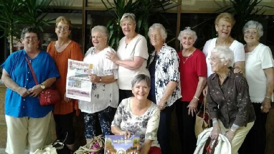 NEWS TRAVEL: At ‘The Lion King’ are Maria Wenberg, Sharon Dalgleish, Dorothy Rule (holding Narooma News), Lorraine Cook, Joan Shipton, Vena Butt, Margaret McCarthy, Joyce Connor and in front: Bronwyn Sloan and Betty Kettlewell.