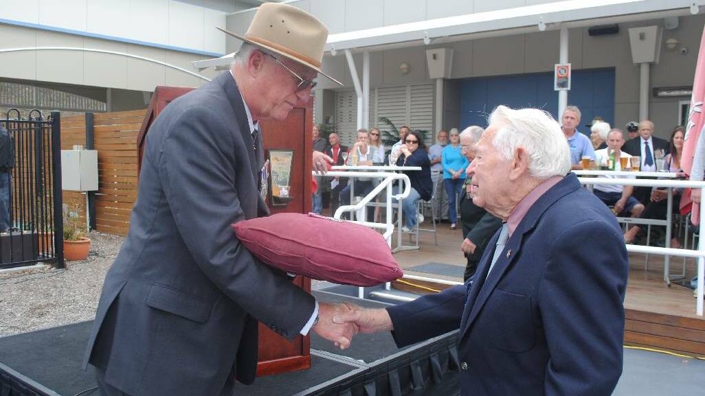 RECIPIENT: Retired Admiral David Shackleton presents George Findley with his service medals from WWII.