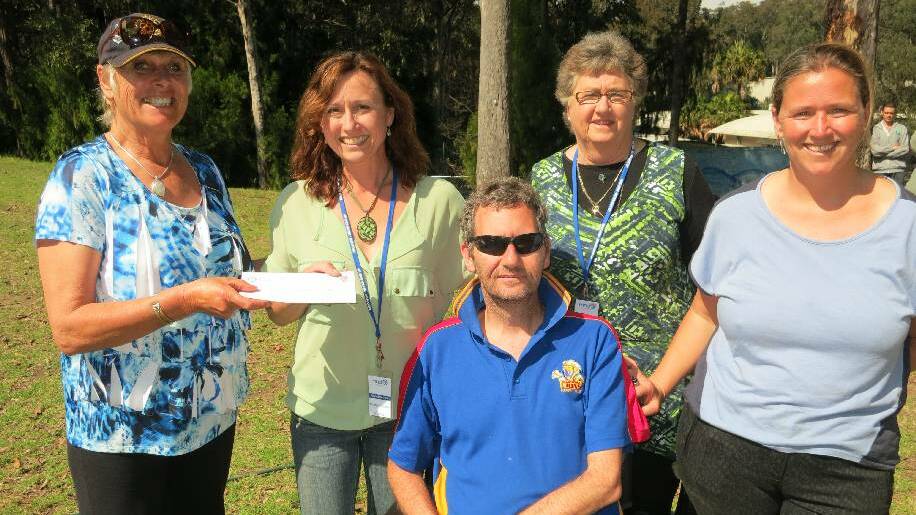 CHECK PRESENTATION: Narooma Rotary Club President Angie Ulrichsen, left, presented Kathryn Ratcliffe with $500 from Narooma Rotary for the MND Research Institute of Australia at the students’ Ice Bucket Challenge last Tuesday. With them are brother Matt Ratcliffe, their Mum and Matt’s wife Steph.