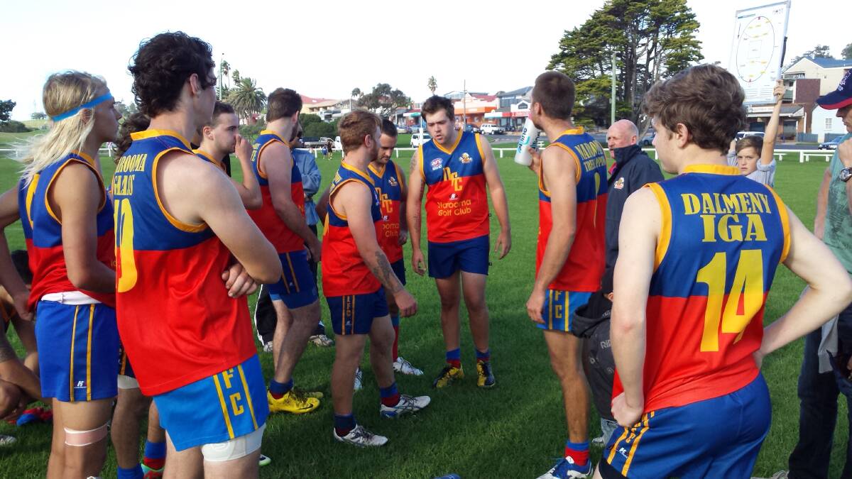 A LEADER EMERGES: Narooma Lions 2014 Captain, Lawrie Hodgson (centre) addresses his troops at halftime on Saturday.

