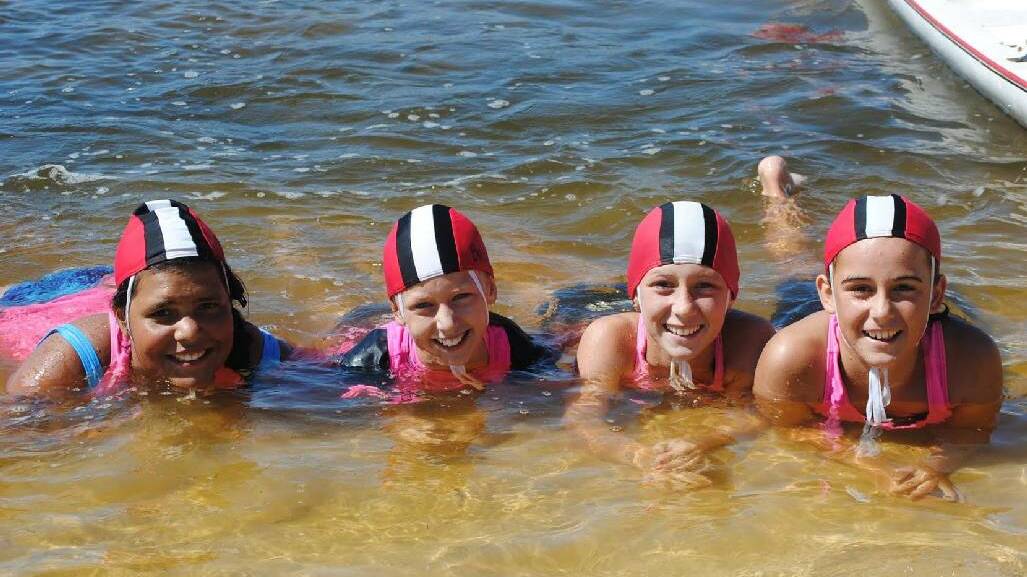NAROOMA SURF CLUB: Cooling off are U11 girls Jemma Laurie, Brooke Stubbs, Hayley Stubbs and Elli Beecham.