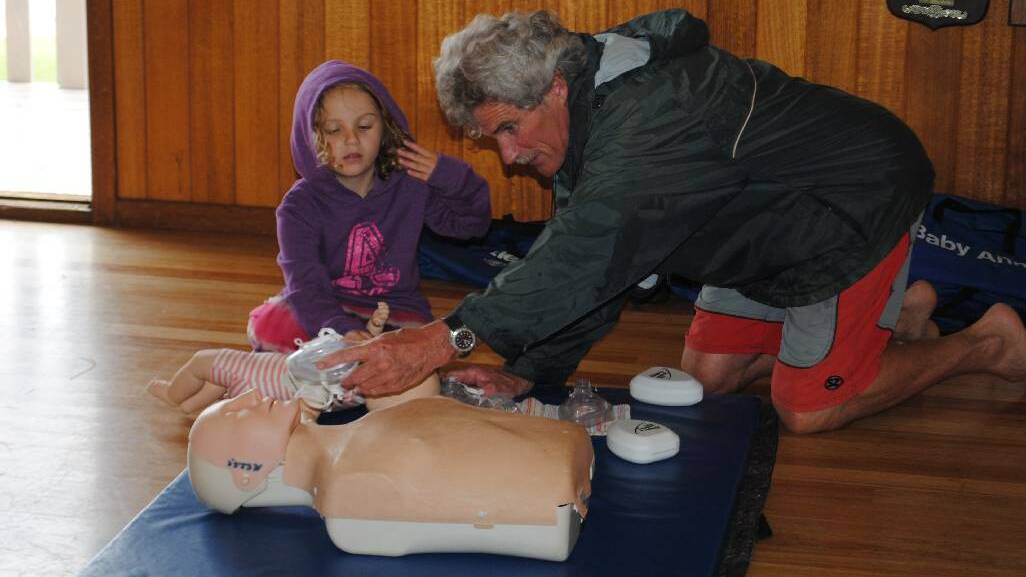 REQUAL DAY: Narooma Surf Lifesaving Club life member Chris Young with granddaughter Meah Beecham practising resuscitation.