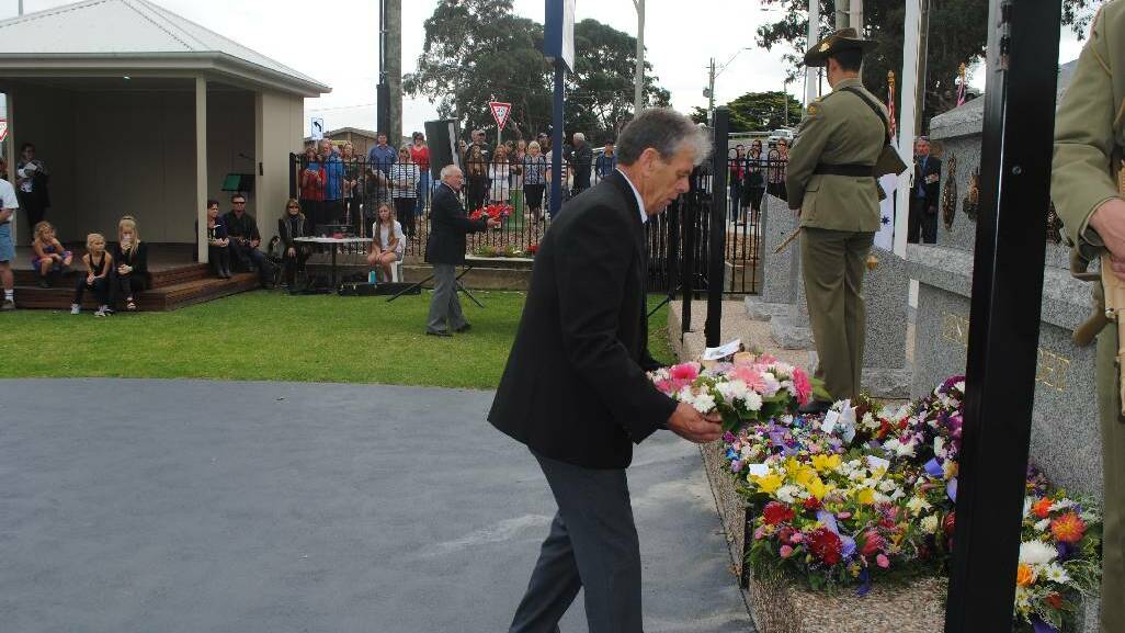 WREATH: Laying a wreath at the Narooma War Memorial is Trevor Bennett.