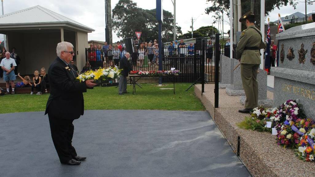 WREATH: Laying a wreath at the Narooma War Memorial is Narooma RSL sub branch president Paul Naylor.