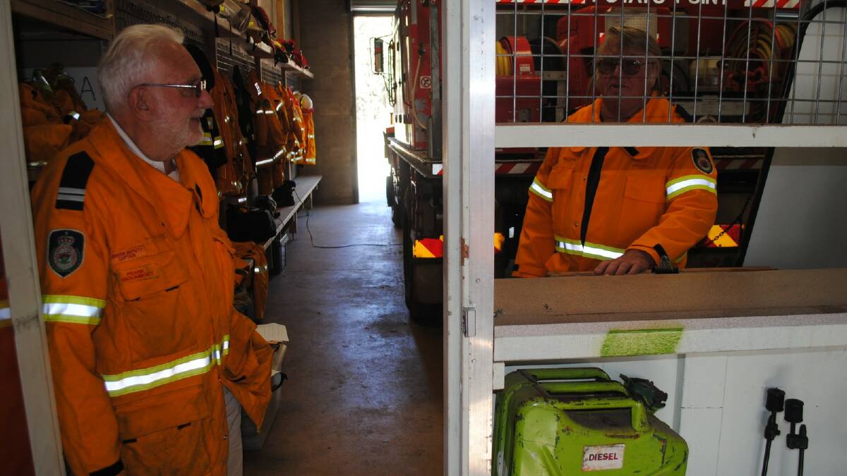 JIMMIED: Potato Point Rural Fire Service Brigade members Frank Vroombout and deputy captain Brian Kennedy examine where thieves used a crow bar to break into stations equipment room. 