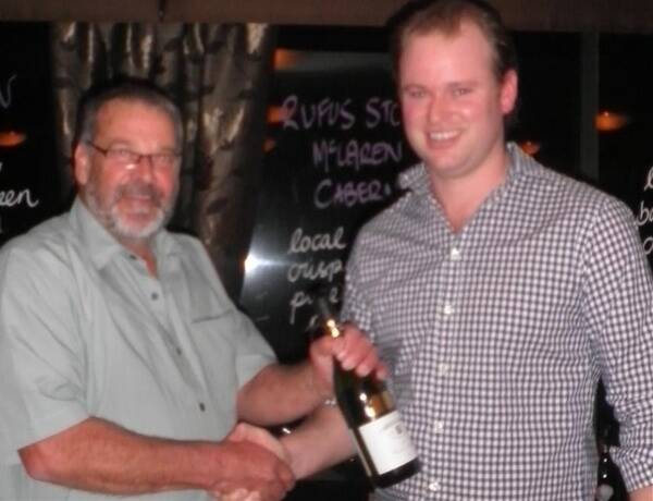 Winner of the wine-guessing competition Tony Brown with Chris Tyrrell.