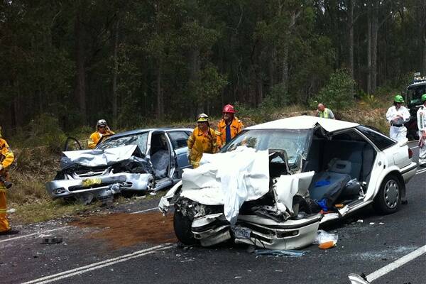 HEAD ON: The aftermath of Sunday’s head-on collision to the north of Bermagui showing police and Volunteer Rescue Association (VRA) members from Narooma responding.
