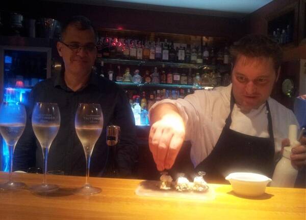 Sous chef Alan Newbold plates up the first course as owner Matt Deveson looks on.