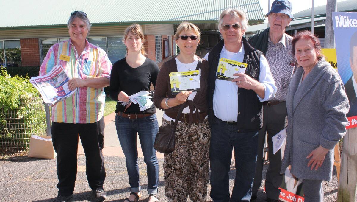 Handing out how-to-vote cards at Tathra Public School are (from left) Ian Robertson, Anatora Wright, Maria and Robert Issell, John Millard and Marion Brunning.