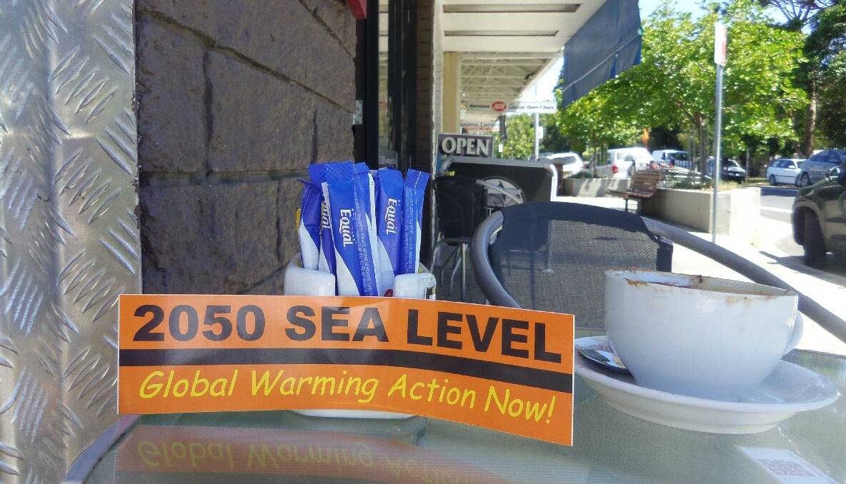 Mysterious global warming stickers around Narooma on Friday. Photo Greg Watts   