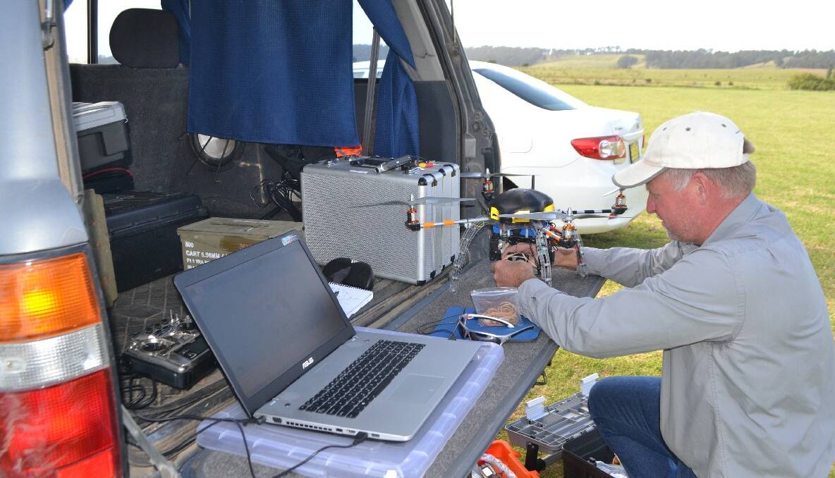 MOBILE OFFICE: From his remote cockpit in the back of his Landcruiser, Warren Purnell programmed a set course for the UAV into his laptop setting out four points at the corners of the sportsground.