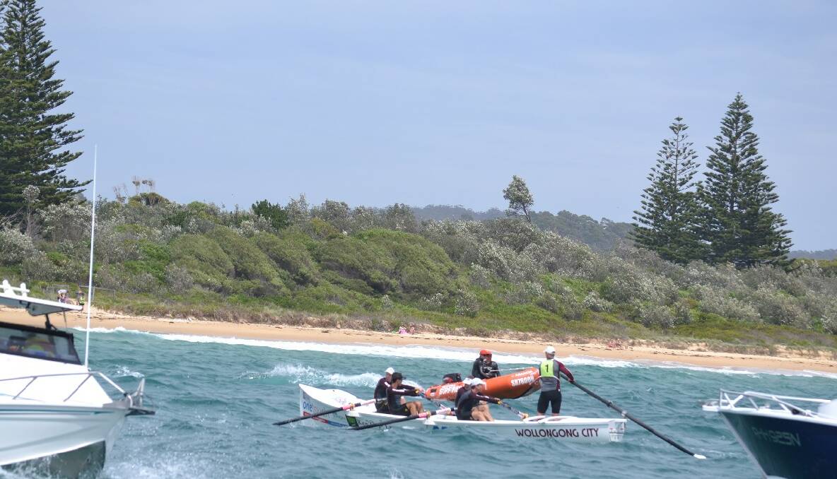 Wollongong City  row to the finish at Bermagui in Day 4 of the 2013/2014 George Bass Surfboat Marathon.